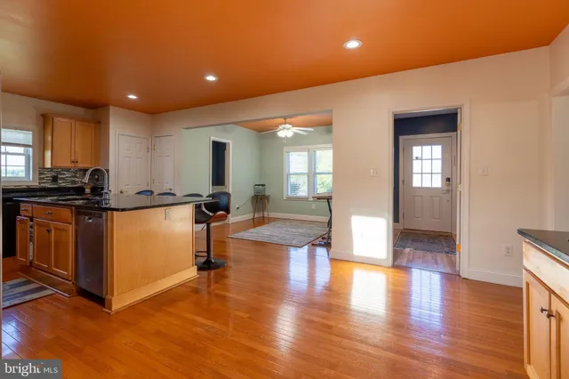 a view of kitchen with cabinets and wooden floor