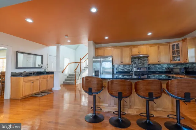 a kitchen with granite countertop a refrigerator and a sink