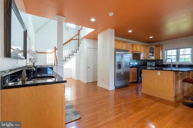 a view of living room with furniture and wooden floor