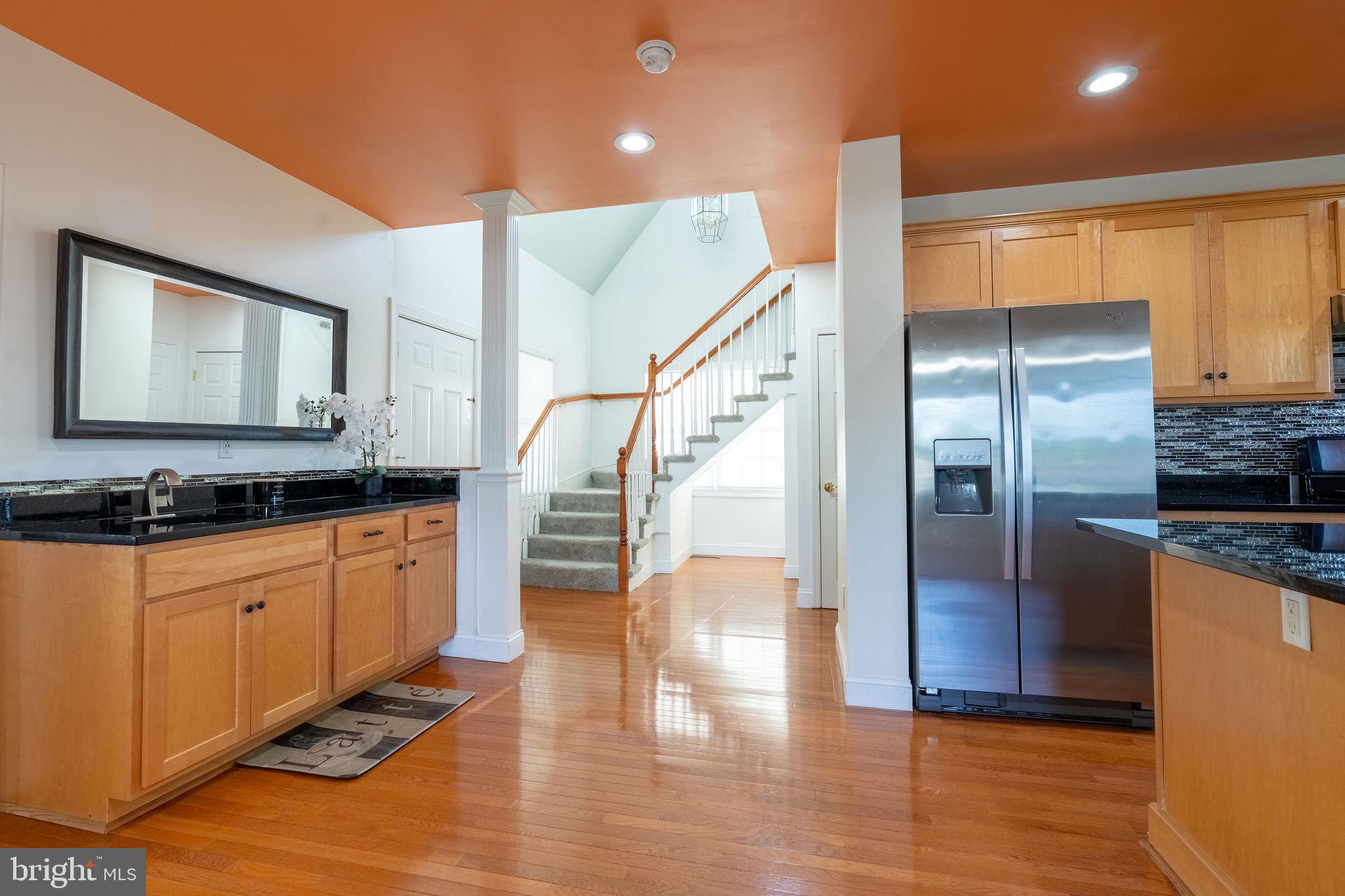 25325 Woodfield Road Damascus, MD 20872 - Photo 33 of 58 a kitchen with granite countertop a refrigerator and a sink