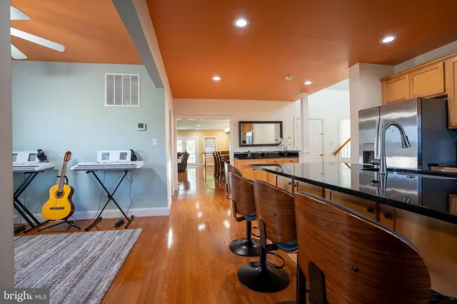a view of entryway and hall with wooden floor