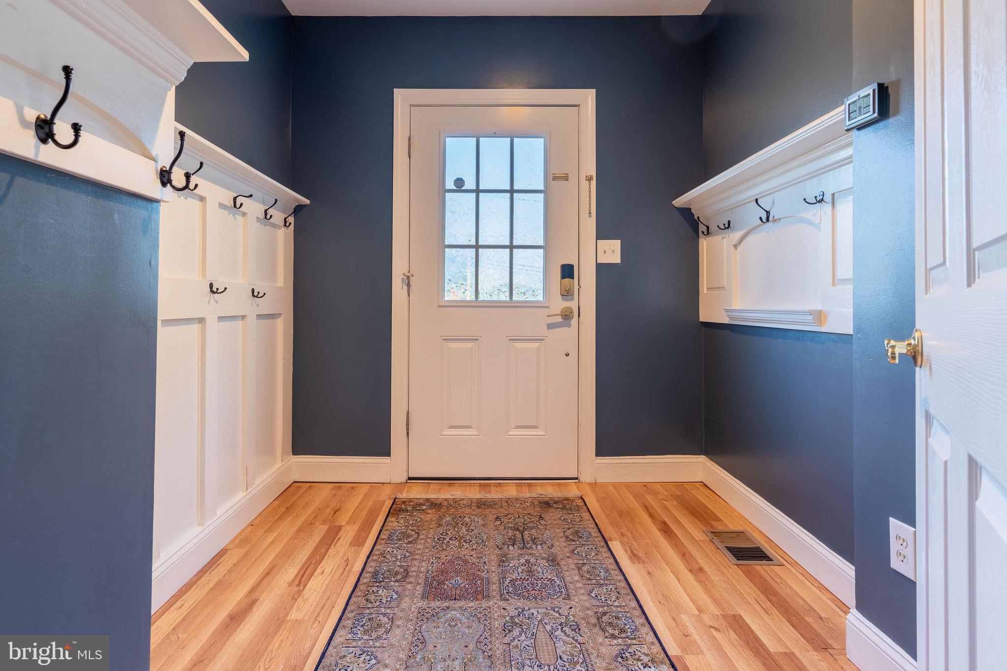 25325 Woodfield Road Damascus, MD 20872 - Photo 35 of 58 a view of a hallway with wooden floor and staircase