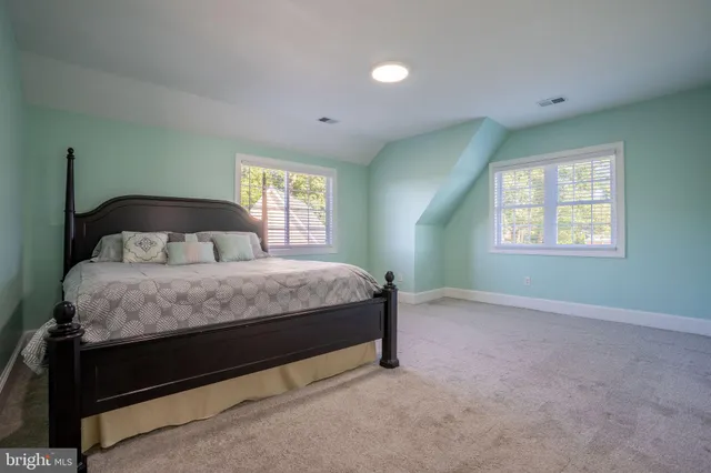 a spacious bathroom with a double vanity sink a mirror and a bathtub