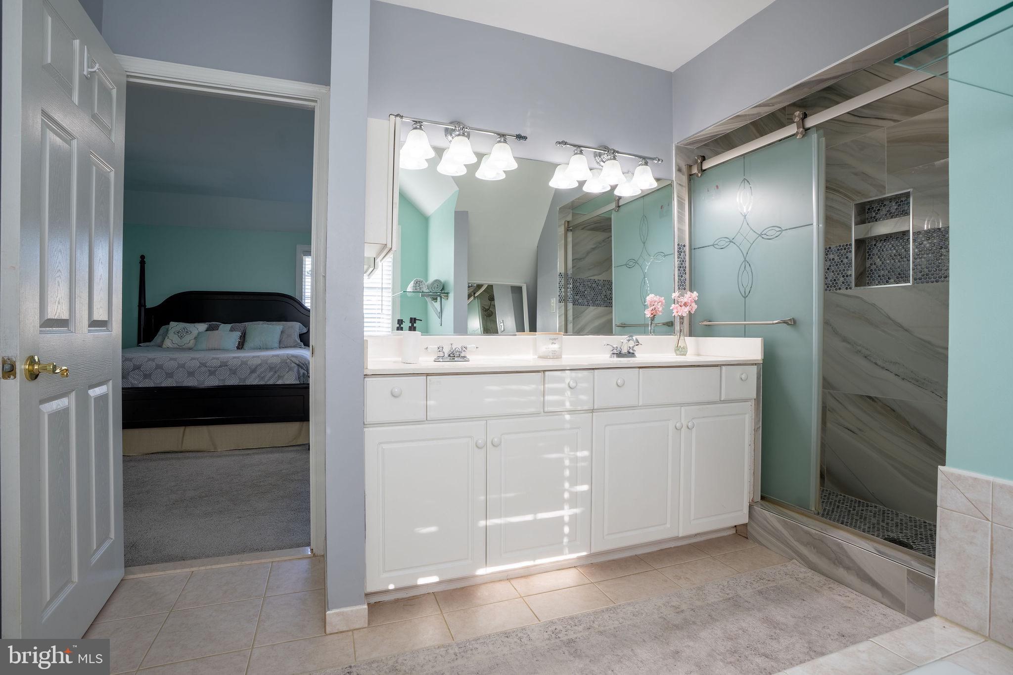 25325 Woodfield Road Damascus, MD 20872 - Photo 41 of 58 a en suite bathroom with a sink double vanity and a mirror