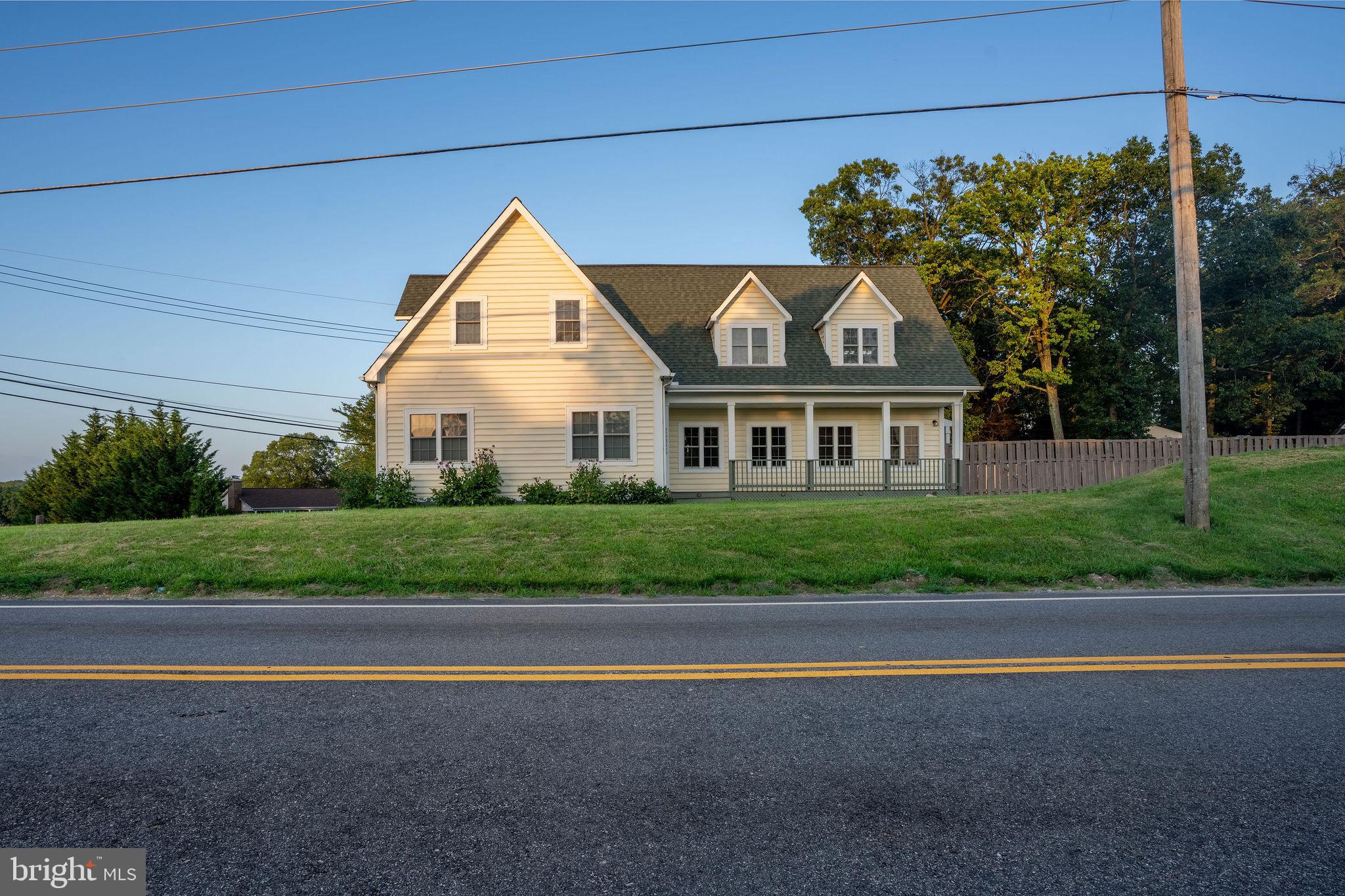 25325 Woodfield Road Damascus, MD 20872 - Photo 6 of 58 a front view of a house with a yard and garage