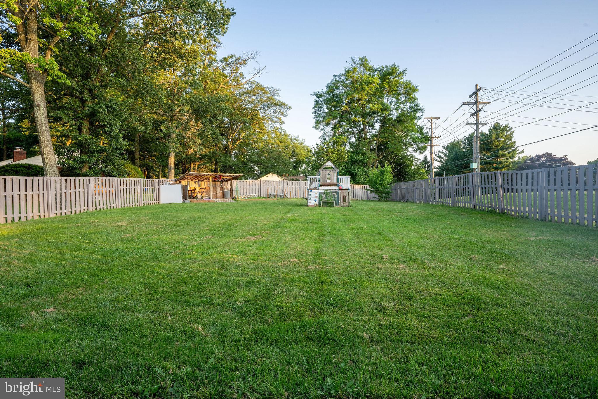 25325 Woodfield Road Damascus, MD 20872 - Photo 7 of 58 a view of a park with large trees and wooden fence