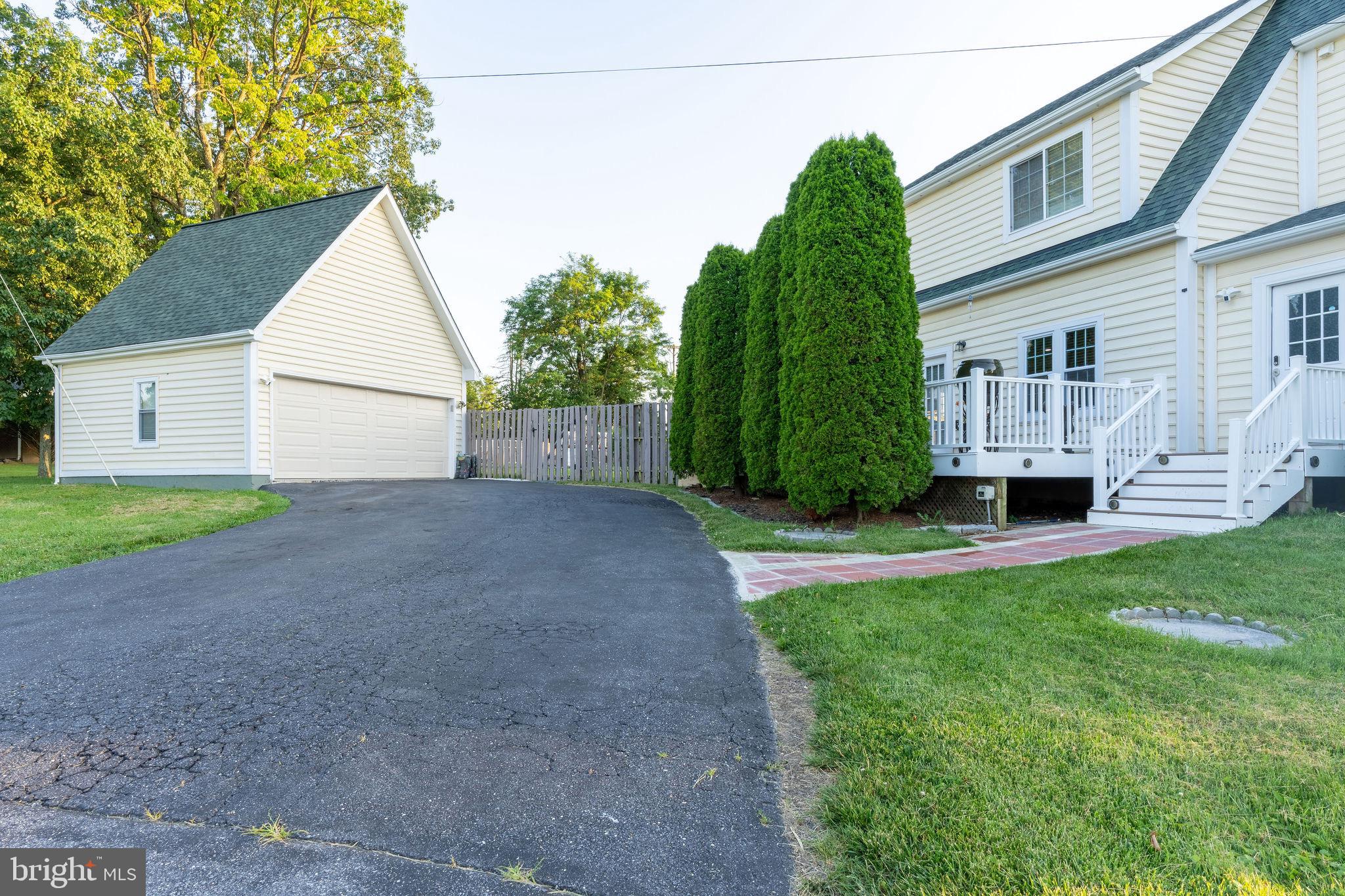 25325 Woodfield Road Damascus, MD 20872 - Photo 8 of 58 a view of a house with backyard and a garden