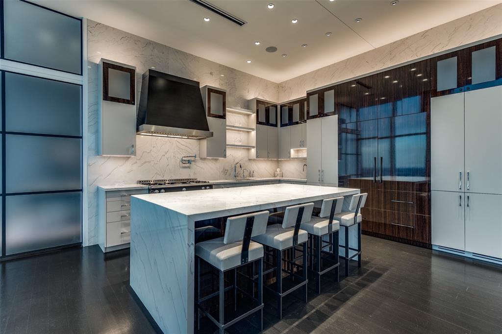 1918 Olive Street, Unit 4202 Dallas, TX 75201 - Photo 11 of 31 a kitchen with stainless steel appliances granite countertop a stove a sink and a refrigerator
