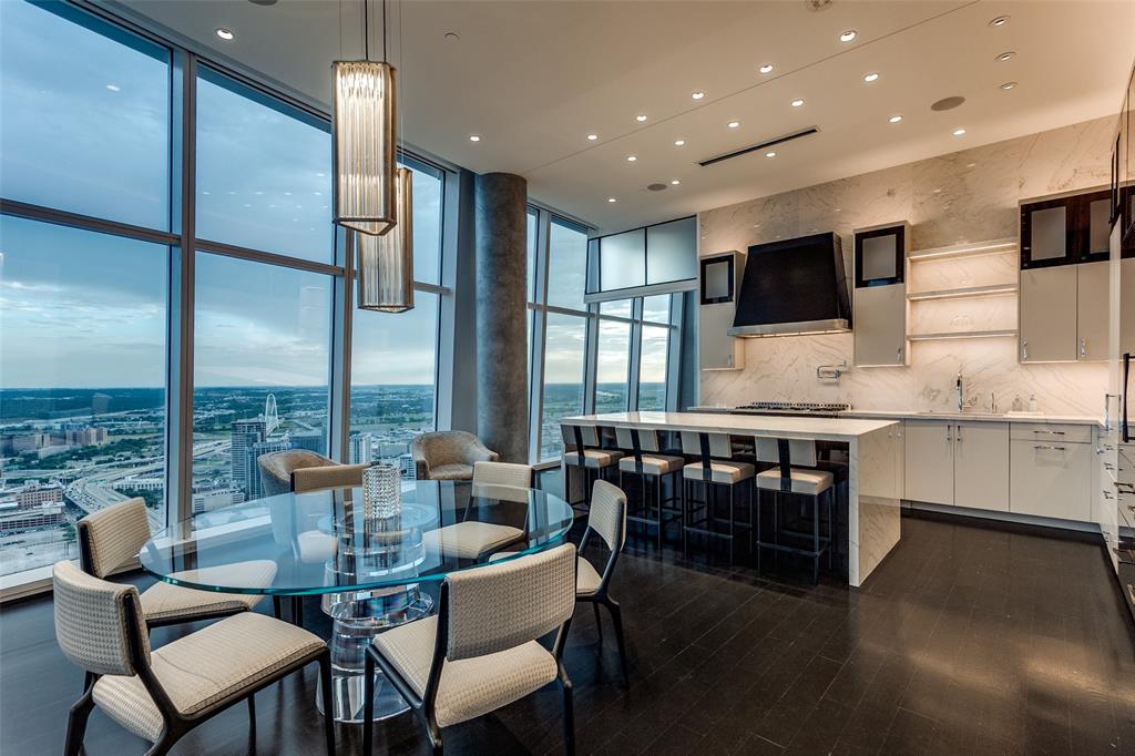 1918 Olive Street, Unit 4202 Dallas, TX 75201 - Photo 13 of 31 a very nice looking kitchen with kitchen island granite countertop a large counter top space and stainless steel appliances