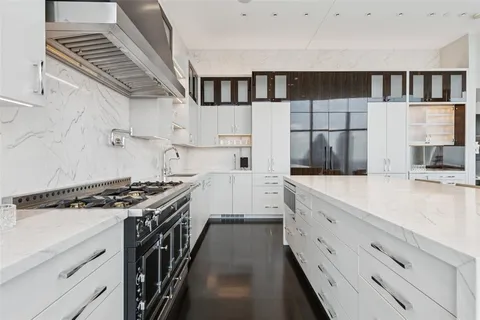 a kitchen with stainless steel appliances granite countertop a stove and a sink