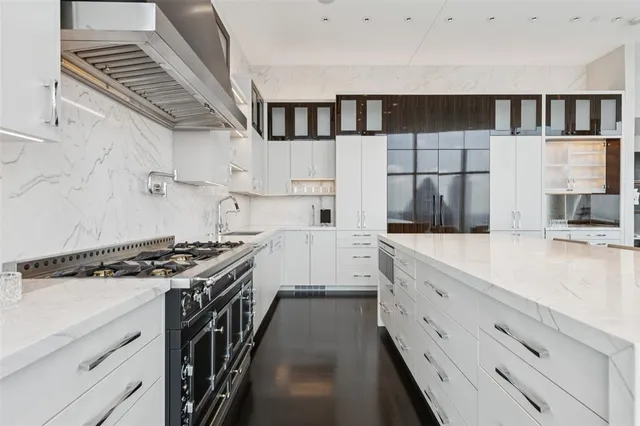 a kitchen with stainless steel appliances granite countertop a stove and a sink