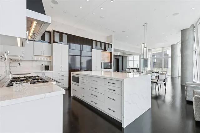 a kitchen with white cabinets and appliances