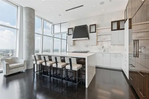 a kitchen with stainless steel appliances kitchen island granite countertop a stove a sink and a microwave