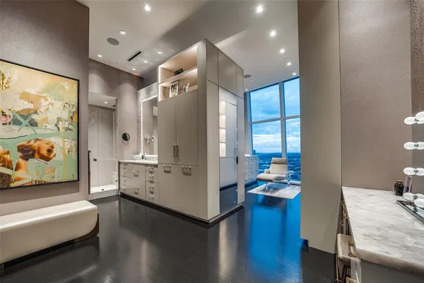 a room with furniture wooden floor and a large window