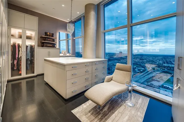 a room with furniture a large window and wooden floors