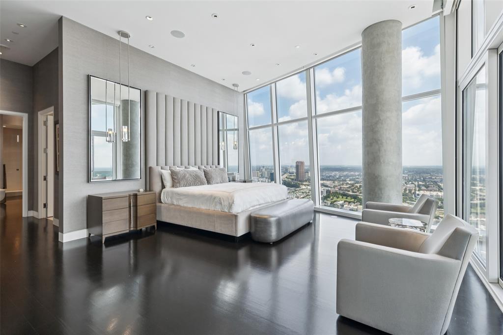 1918 Olive Street, Unit 4202 Dallas, TX 75201 - Photo 22 of 37 a spacious bedroom with a large window and a wooden floor