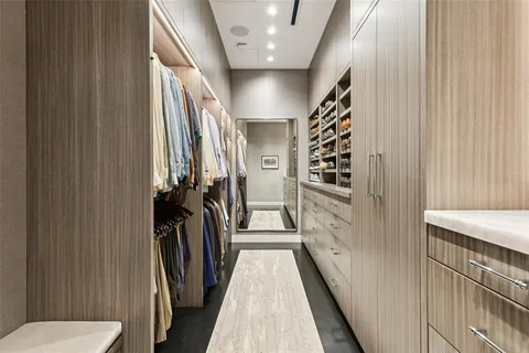 a view of a hallway with a door and furniture