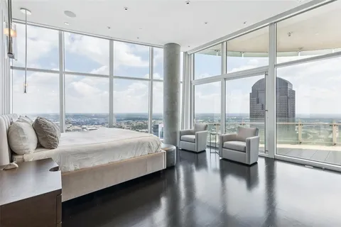 a bedroom with a bed and large window