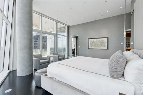 a bedroom with a large bed and a large window