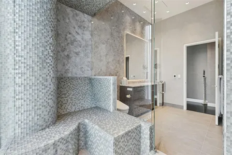 a spacious bathroom with a granite countertop sink a toilet and shower