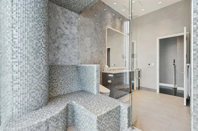 a spacious bathroom with a granite countertop sink a toilet and shower