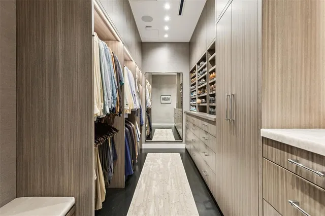 a view of a hallway with a door and furniture