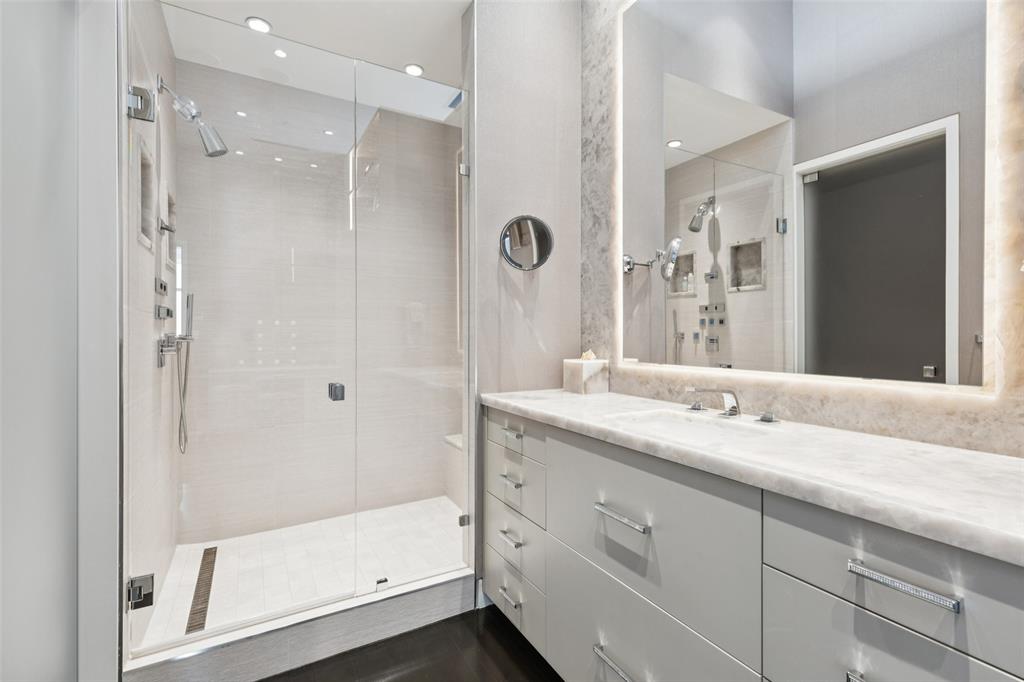 1918 Olive Street, Unit 4202 Dallas, TX 75201 - Photo 27 of 31 a bathroom with a granite countertop sink mirror and shower