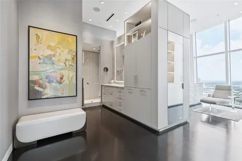 a room with furniture a large window and wooden floors