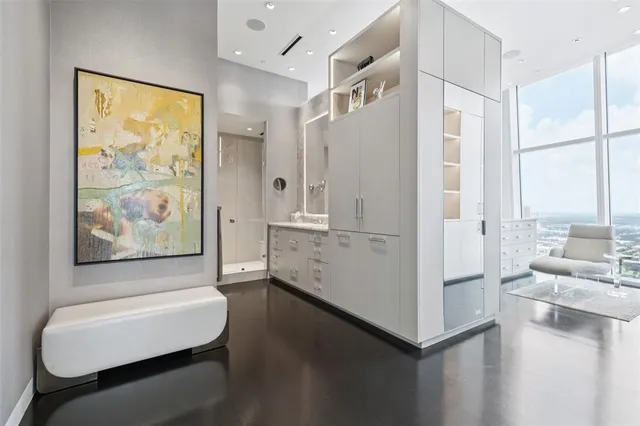 a room with furniture a large window and wooden floors