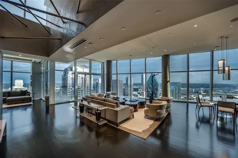 a living room with patio furniture and a wooden floor