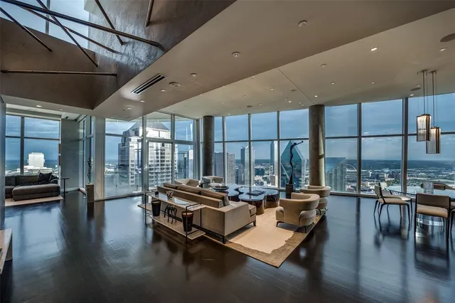 a living room with patio furniture and a wooden floor