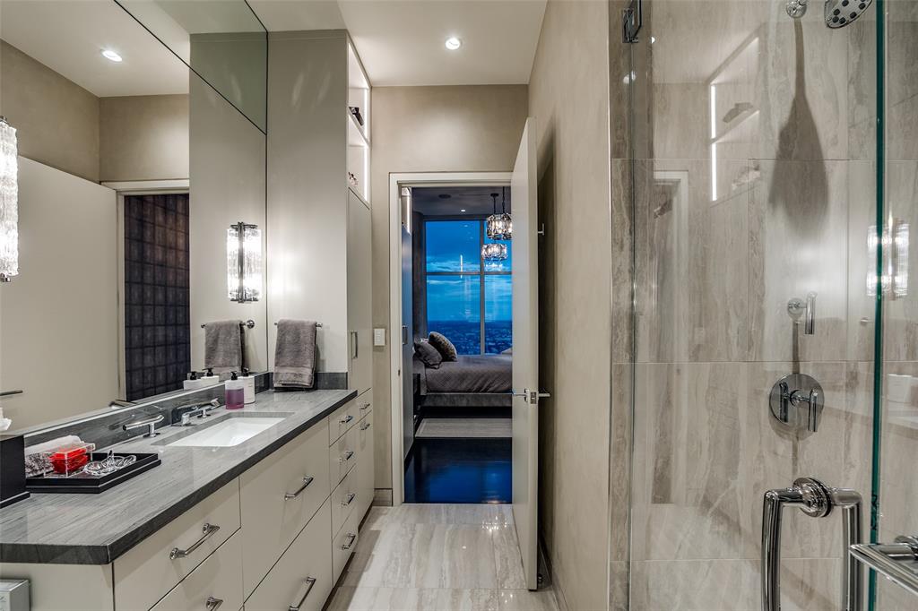 1918 Olive Street, Unit 4202 Dallas, TX 75201 - Photo 32 of 37 a en suite bathroom with a double vanity sink and a mirror