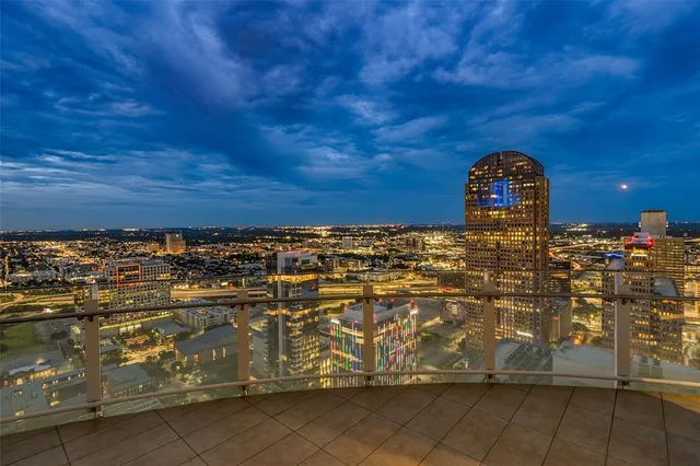 a view of a patio with table and chairs potted plants and large tree