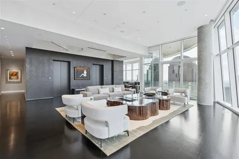 a view of a dining room with furniture a chandelier and wooden floor