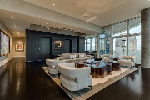 a living room with fireplace furniture and a large window