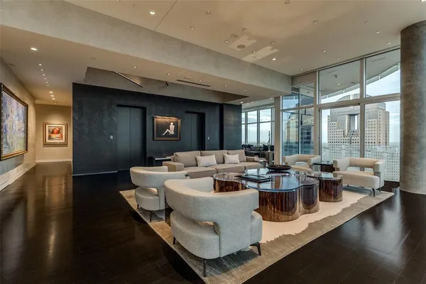 a living room with fireplace furniture and a large window