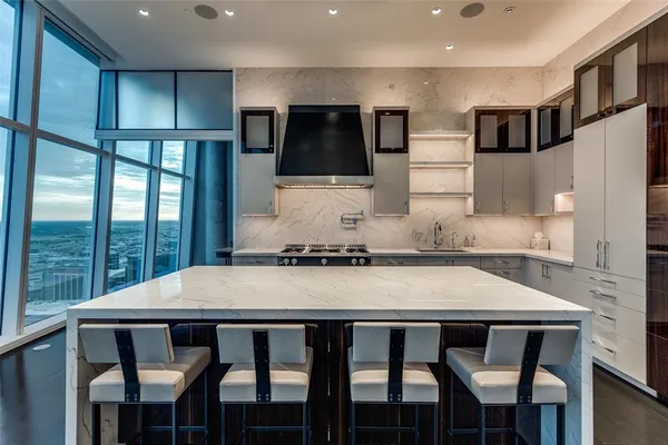 a kitchen with a table chairs refrigerator and microwave