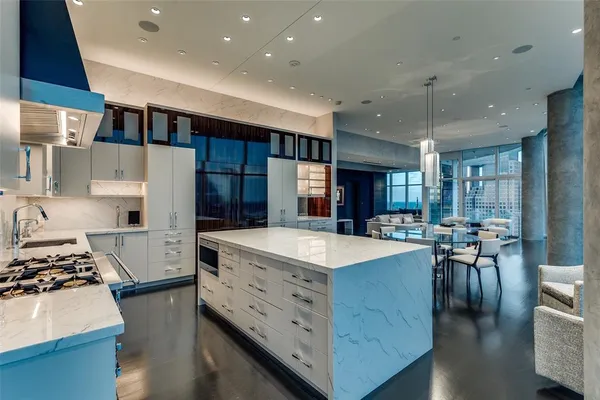 a large kitchen with stainless steel appliances lots of counter space and breakfast area