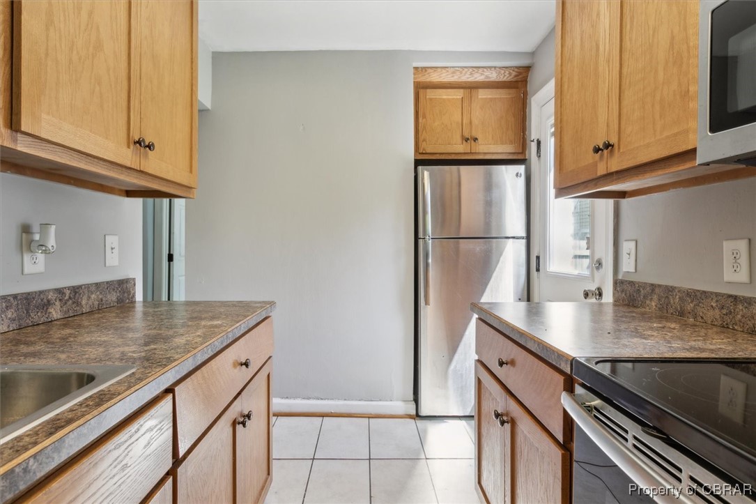 3810 Kecoughtan Road Hampton, VA 23669 - Photo 18 of 40 Kitchen with appliances with stainless steel finishes and light tile patterned floors
