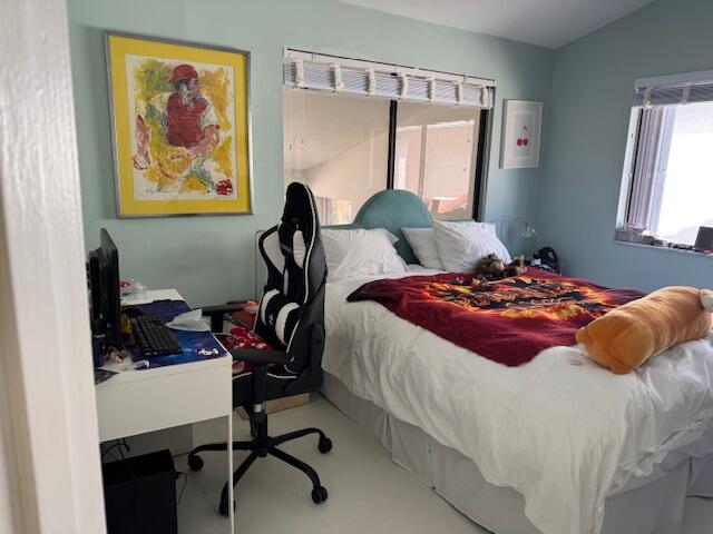 5544 Fox Hollow Drive Boca Raton, FL 33486 - Photo 16 of 22 a bedroom with a bed and wooden floor
