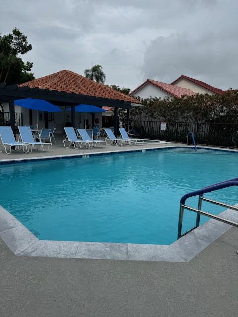 5544 Fox Hollow Drive Boca Raton, FL 33486 - Photo 22 of 22 a front view of a house with swimming pool and a yard