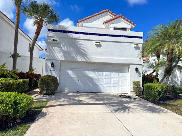 5544 Fox Hollow Drive Boca Raton, FL 33486 - Photo 3 of 22 a front view of a house with a yard