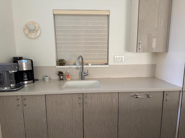 5544 Fox Hollow Drive Boca Raton, FL 33486 - Photo 7 of 22 a kitchen with cabinets and window