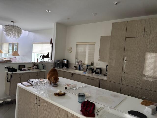 5544 Fox Hollow Drive Boca Raton, FL 33486 - Photo 10 of 22 a kitchen with kitchen island a sink stove and refrigerator