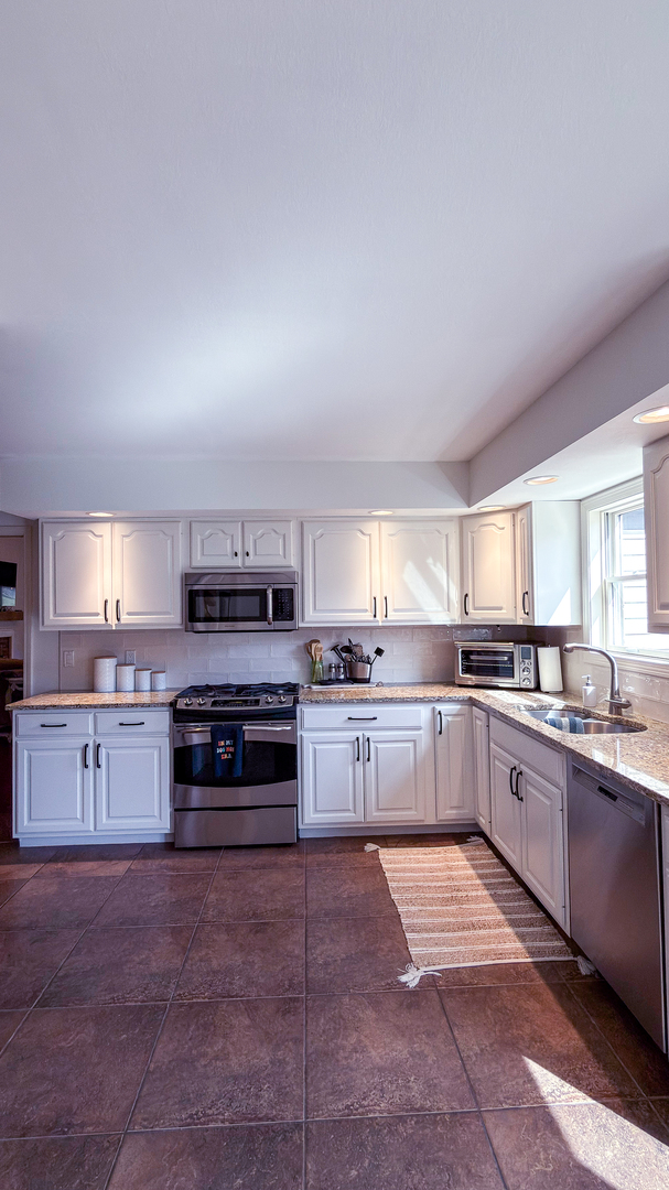 2902 Greystone Place Champaign, IL 61822 - Photo 14 of 35 a large kitchen with a stove top oven