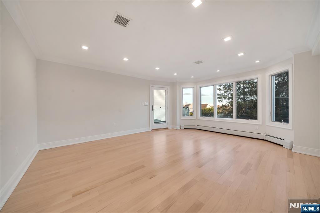 516 Undercliff Avenue Edgewater, NJ 07020 - Photo 15 of 32 a view of an empty room with wooden floor and a window