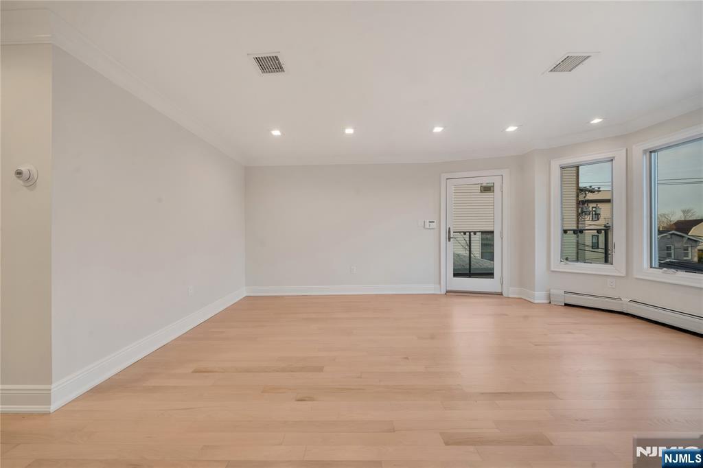516 Undercliff Avenue Edgewater, NJ 07020 - Photo 16 of 32 a view of an empty room with window and stairs