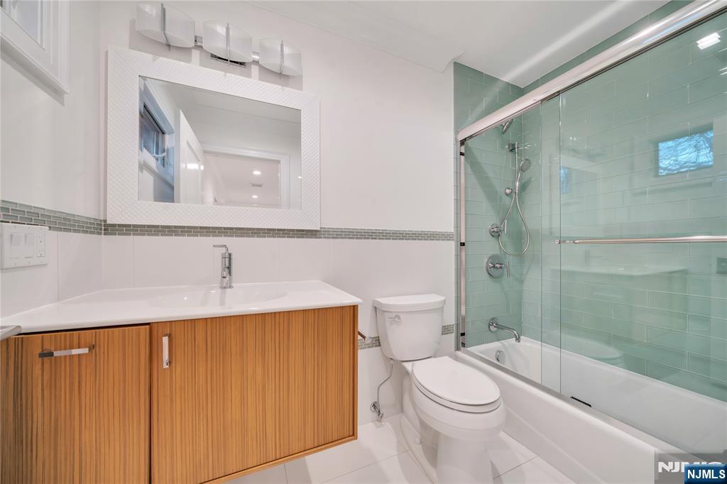 516 Undercliff Avenue Edgewater, NJ 07020 - Photo 24 of 32 a bathroom with a sink a toilet and shower