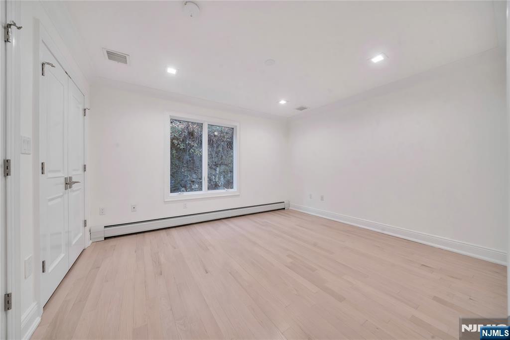 516 Undercliff Avenue Edgewater, NJ 07020 - Photo 27 of 32 a view of an empty room with a window
