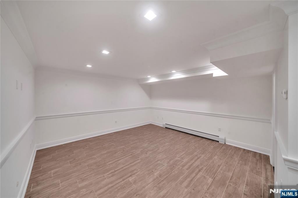 516 Undercliff Avenue Edgewater, NJ 07020 - Photo 31 of 32 a view of an empty room with wooden floor